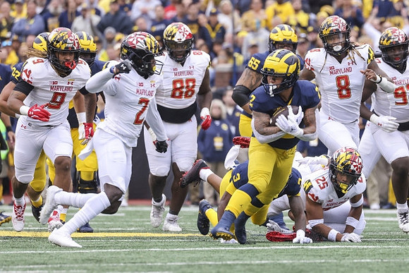Blake Corum (2), A.J. Henning (3), and Zak Zinter (65)