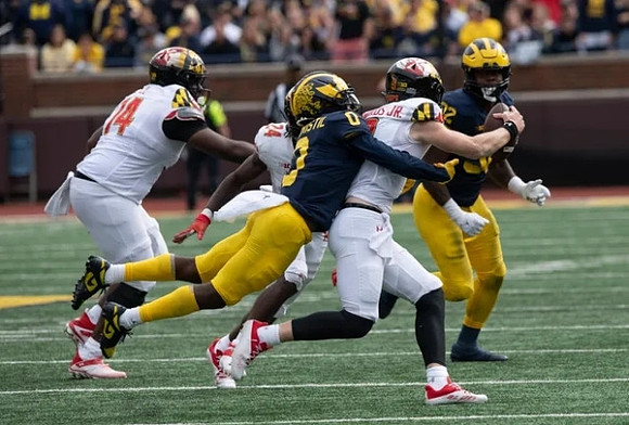 Mike Sainristil (0) and Jaylen Harrell (32)