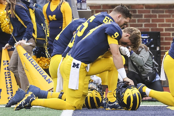 J.J. McCarthy (9) and Zak Zinter (65)