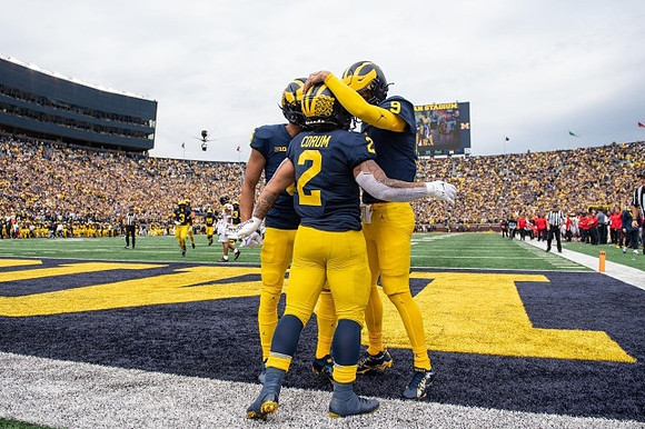 Ronnie Bell (8), Blake Corum (2), and J.J. McCarthy (9)