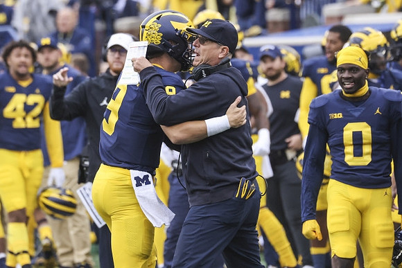 J.J. McCarthy (9), Jim Harbaugh, and Mike Sainristil (0)