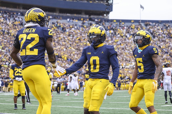 Junior Colson (25), Gemon Green (22), Mike Sainristil (0), and DJ Turner (5)