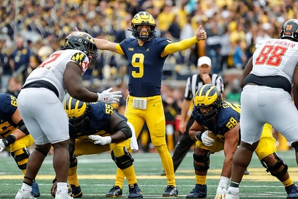 Zak Zinter (65), Olusegun Oluwatimi (55), J.J. McCarthy (9), and Giovanni El-Hadi (58)