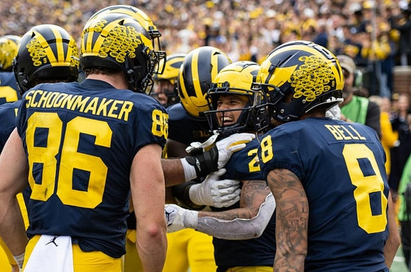 Luke Schoonmaker (86), Blake Corum (2), and Ronnie Bell (8)