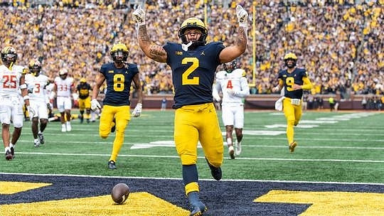 Ronnie Bell (8), Blake Corum (2), and J.J. McCarthy (9)