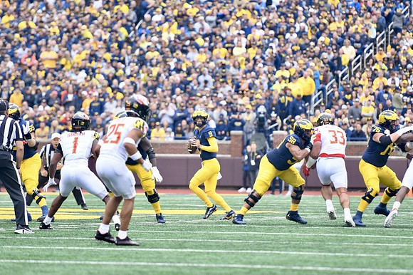 Zak Zinter (65), J.J. McCarthy (9), Giovanni El-Hadi (58), and Ryan Hayes (76)