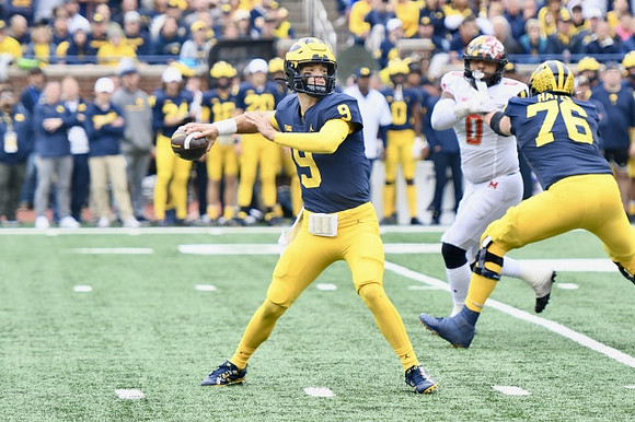 J.J. McCarthy (9) and Ryan Hayes (76)