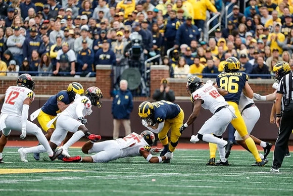 Cornelius Johnson (6), Blake Corum (2), and Luke Schoonmaker (86)