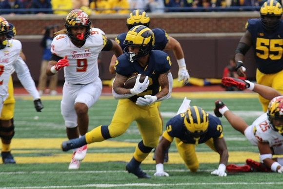 Blake Corum (2), A.J. Henning (3), and Olusegun Oluwatimi (55)