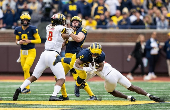 J.J. McCarthy (9), Luke Schoonmaker (86), and Blake Corum (2)