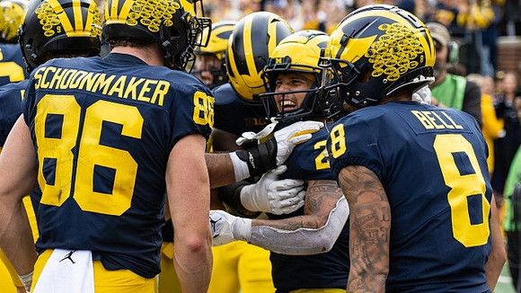 Luke Schoonmaker (86), Blake Corum (2), and Ronnie Bell (8)