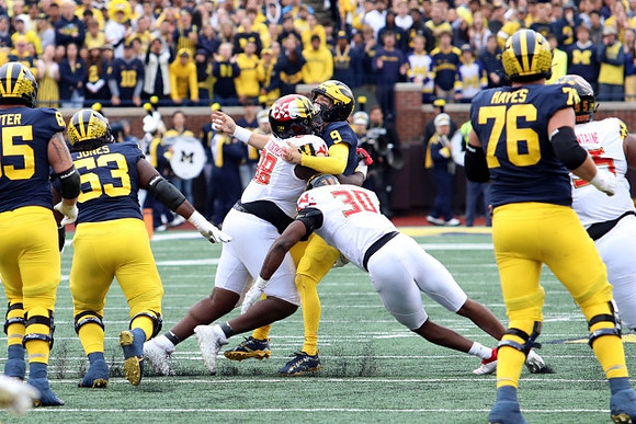 Zak Zinter (65), Trente Jones (53), J.J. McCarthy (9), and Ryan Hayes (76)