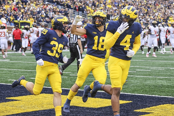 Joe Taylor (39), Colston Loveland (18), and Micah Pollard (4)