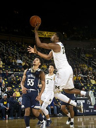 D.J. Wilson (5) and Zak Irvin (21)