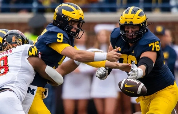 J.J. McCarthy (9) and Ryan Hayes (76)