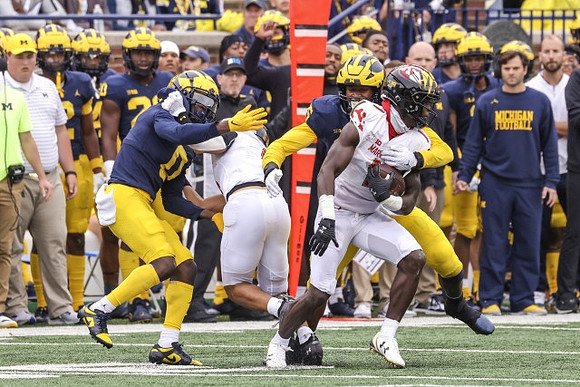 Mike Sainristil (0) and DJ Turner (5)