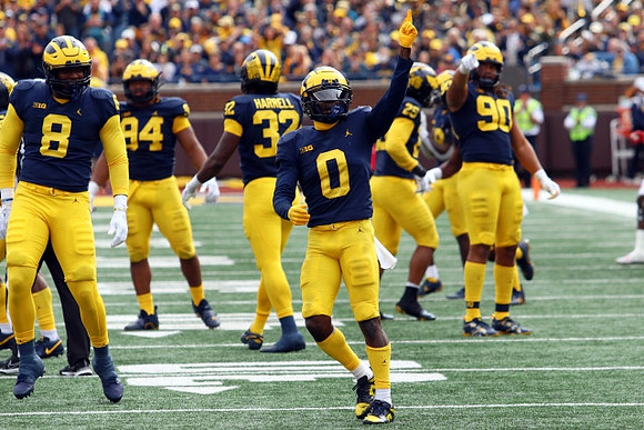 Derrick Moore (8), Kris Jenkins (94), Jaylen Harrell (32), Mike Sainristil (0), Junior Colson (25), and Mike Morris (90)