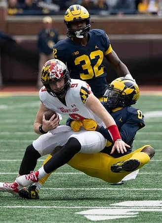 Mike Sainristil (0) and Jaylen Harrell (32)