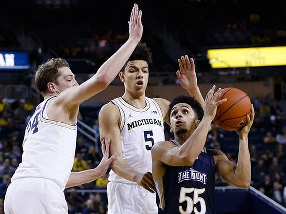 Mark Donnal (34) and D.J. Wilson (5)