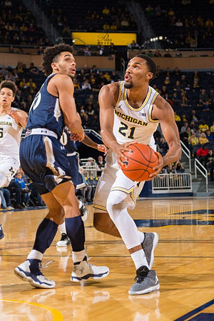 D.J. Wilson (5) and Zak Irvin (21)