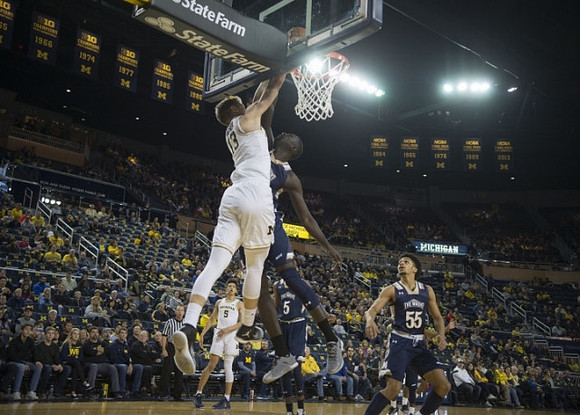 Moritz Wagner (13) and D.J. Wilson (5)
