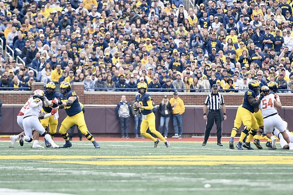 Zak Zinter (65), J.J. McCarthy (9), and Olusegun Oluwatimi (55)