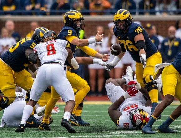 Olusegun Oluwatimi (55), J.J. McCarthy (9), and Ryan Hayes (76)