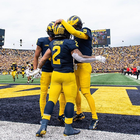 Ronnie Bell (8), Blake Corum (2), and J.J. McCarthy (9)