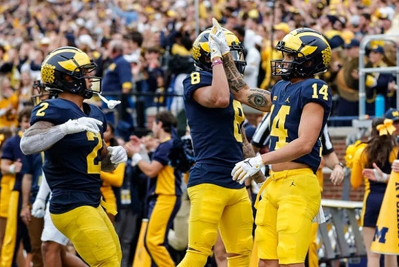 Blake Corum (2), Ronnie Bell (8), and Roman Wilson (14)
