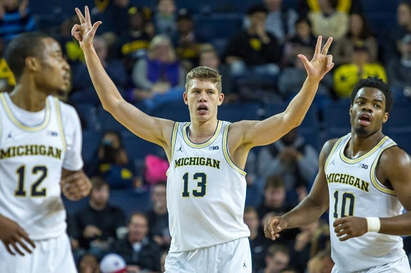 Muhammad-Ali Abdur-Rahkman (12), Moritz Wagner (13), and Derrick Walton Jr. (10)