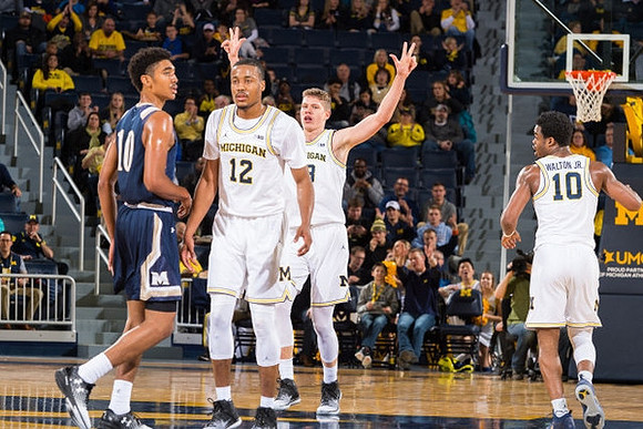 Muhammad-Ali Abdur-Rahkman (12), Moritz Wagner (13), and Derrick Walton Jr. (10)