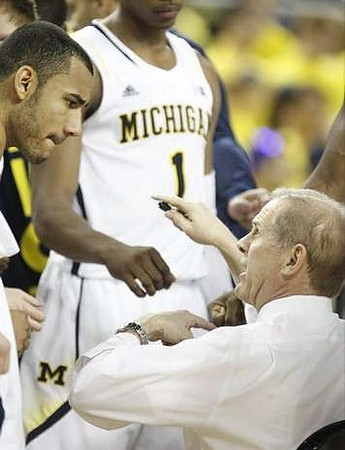 Jon Horford (15), Glenn Robinson III (1), and John Beilein