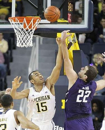 Trey Burke (3) and Jon Horford (15)