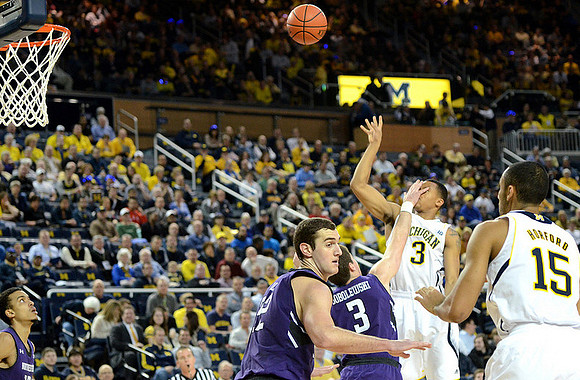 Trey Burke (3) and Jon Horford (15)