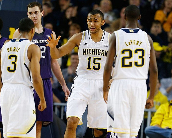 Trey Burke (3), Jon Horford (15), and Caris LeVert (23)