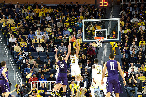 Jon Horford (15), Tim Hardaway Jr. (10), and Caris LeVert (23)