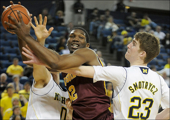 Zack Novak (0) and Evan Smotrycz (23)