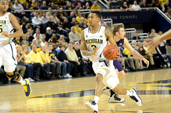 Jon Horford (15) and Trey Burke (3)
