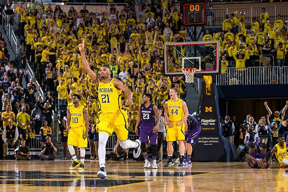Derrick Walton Jr. (10), Zak Irvin (21), and Max Bielfeldt (44)