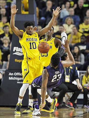 Derrick Walton Jr. (10) and Caris LeVert (23)