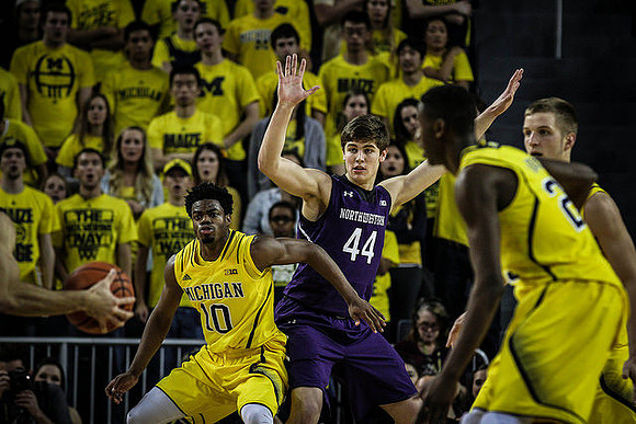 Derrick Walton Jr. (10), Caris LeVert (23), and Max Bielfeldt (44)