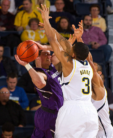 Trey Burke (3) and Jon Horford (15)