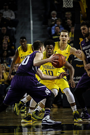 Caris LeVert (23), Derrick Walton Jr. (10), and Mark Donnal (34)
