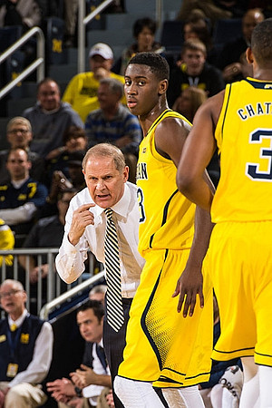 John Beilein, Caris LeVert (23), and Kameron Chatman (3)