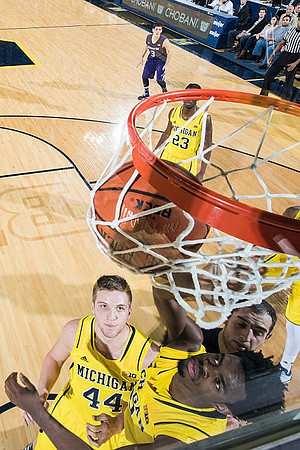 Max Bielfeldt (44), Derrick Walton Jr. (10), and Caris LeVert (23)
