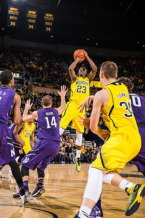Caris LeVert (23), Zak Irvin (21), and Mark Donnal (34)