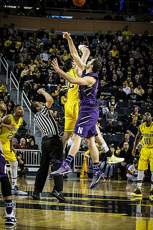 Zak Irvin (21), Ricky Doyle (32), and Derrick Walton Jr. (10)
