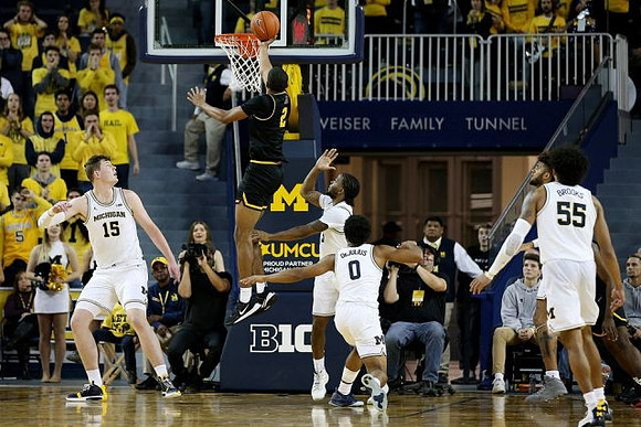 Jon Teske (15), Zavier Simpson (3), David DeJulius (0), and Eli Brooks (55)