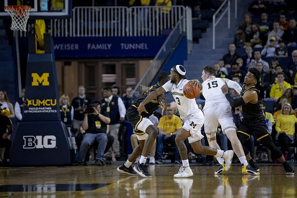 Zavier Simpson (3) and Jon Teske (15)