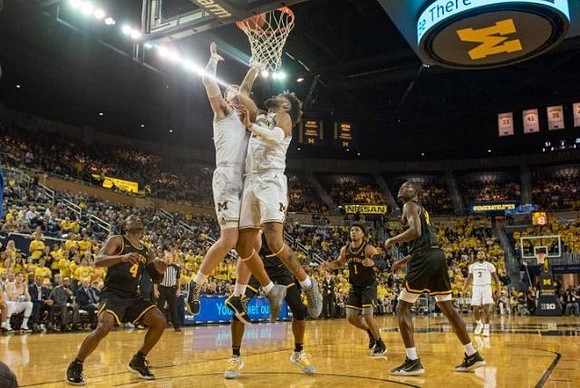 Jon Teske (15), Isaiah Livers (2), and Zavier Simpson (3)
